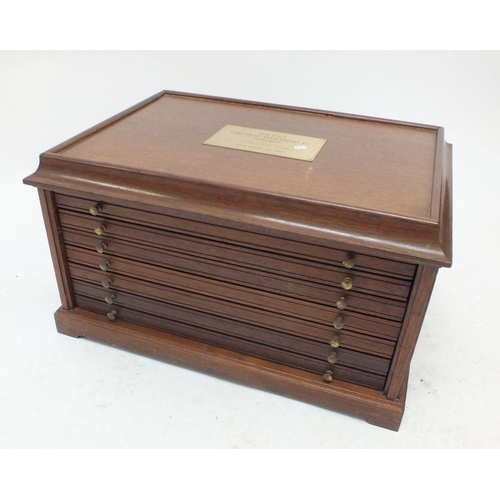 378 - A wooden coin cabinet with five drawers each fitted twenty crown sized pockets plus a deeper bottom ... 