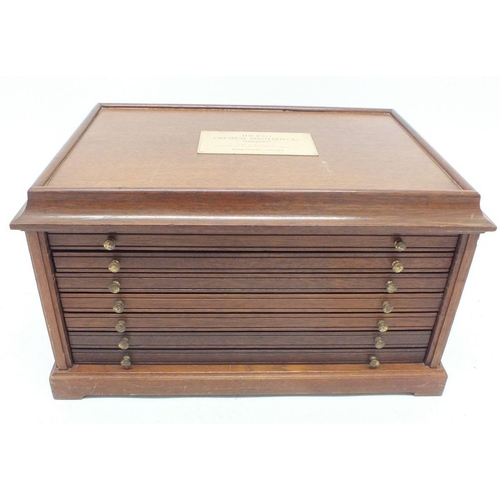 378 - A wooden coin cabinet with five drawers each fitted twenty crown sized pockets plus a deeper bottom ... 