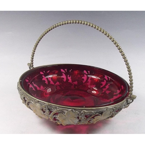 514 - A cranberry glass bowl in gilt metal vine cast stand