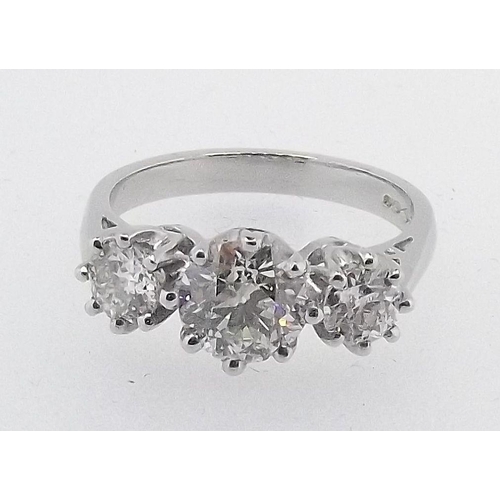 573 - A platinum three stone diamond ring, central stone measuring 1.20ct,   total estimated diamond weigh... 