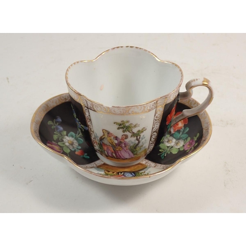 112 - A Dresden porcelain cabinet cup and saucer,  painted panels of flowers and courting scenes, A R mark