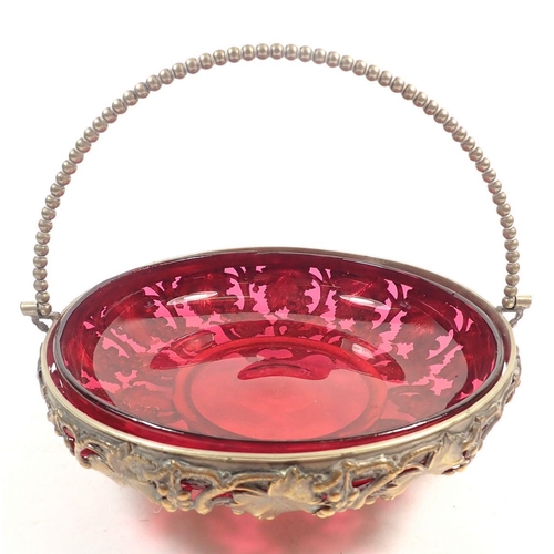 152 - A cranberry glass bowl in gilt metal vine cast stand