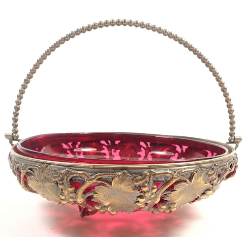 152 - A cranberry glass bowl in gilt metal vine cast stand