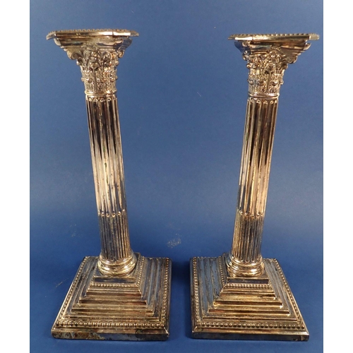 166 - A pair of large silver-plated Corinthian column candlesticks, 29cm