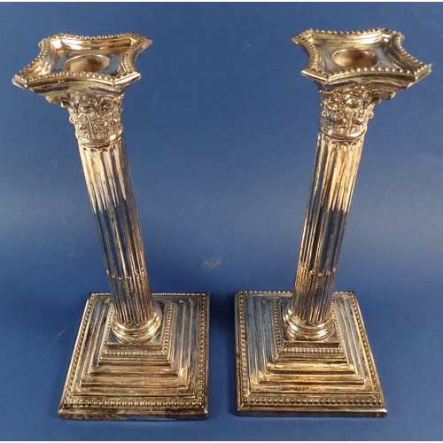 166 - A pair of large silver-plated Corinthian column candlesticks, 29cm