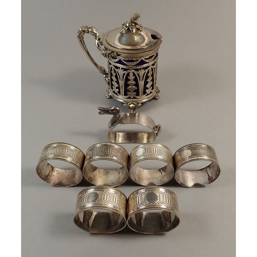 170 - A Victorian silver-plated pierced mustard pot,  'duck' napkin ring and six other napkin rings