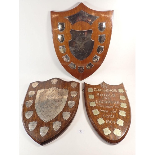 181 - An oak lacrosse shield from Princess Helena College set with silver plaques and two similar,  with s... 