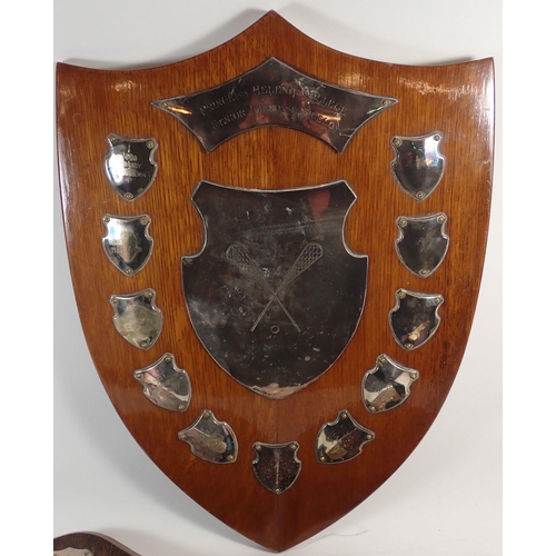 181 - An oak lacrosse shield from Princess Helena College set with silver plaques and two similar,  with s... 