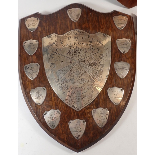 181 - An oak lacrosse shield from Princess Helena College set with silver plaques and two similar,  with s... 