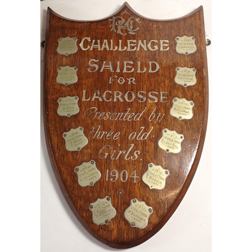 181 - An oak lacrosse shield from Princess Helena College set with silver plaques and two similar,  with s... 