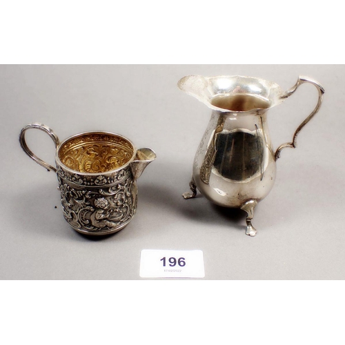 196 - A Victorian silver cream jug with embossed cherub and scrollwork decoration, Chester 1898 and a crea... 