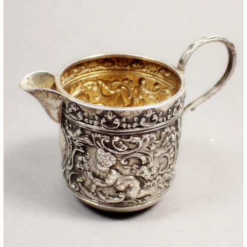 196 - A Victorian silver cream jug with embossed cherub and scrollwork decoration, Chester 1898 and a crea... 