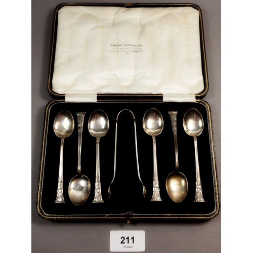 211 - A cased set of six Egyptian style silver teaspoons and sugar tongs, Sheffield 1923, Maker William Ga... 