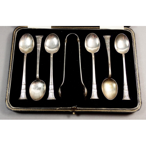 211 - A cased set of six Egyptian style silver teaspoons and sugar tongs, Sheffield 1923, Maker William Ga... 