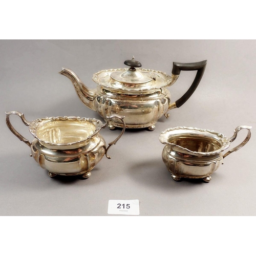 215 - A silver three-piece tea service with decorative scrollwork border, Birmingham 1912, 708g