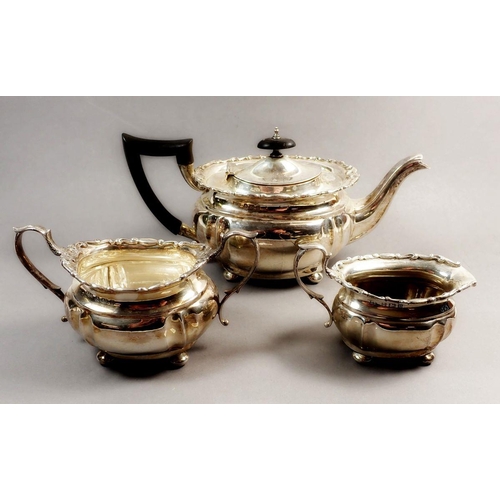 215 - A silver three-piece tea service with decorative scrollwork border, Birmingham 1912, 708g