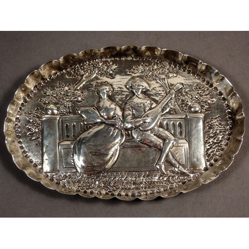 233 - A Victorian silver pin dish/trinket dish of oval form, repousse decoration of a seated lady and gent... 