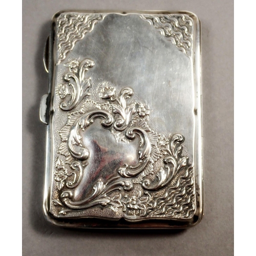 237 - An Edwardian silver note case with scroll decoration and fitted interior containing a pencil and ivo... 