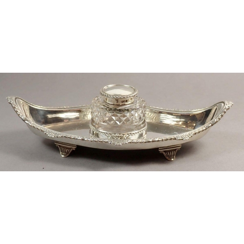 242 - A late Victorian silver inkstand of lozenge shape, raised on four feet with singe cut glass bottle a... 