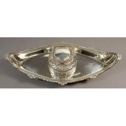 242 - A late Victorian silver inkstand of lozenge shape, raised on four feet with singe cut glass bottle a... 