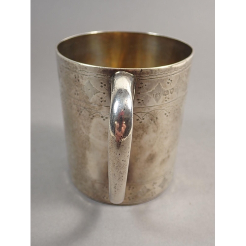 243 - A Victorian silver mug with engraved decoration, London 1871 by Thomas Smily, 147g 8cm tall