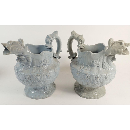 29 - Two pairs of early Victorian mask jugs with stylised dolphin handles and spouts, 21cm tall
