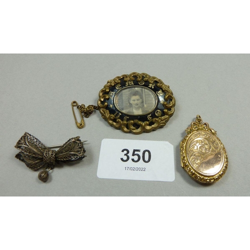 350 - A 19th century mourning brooch, a 9ct gold back and front locket and a white metal filigree bow broo... 