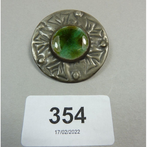 354 - An Arts and Crafts Ruskin pewter brooch inset with pottery type cabochon 3.8cm diameter