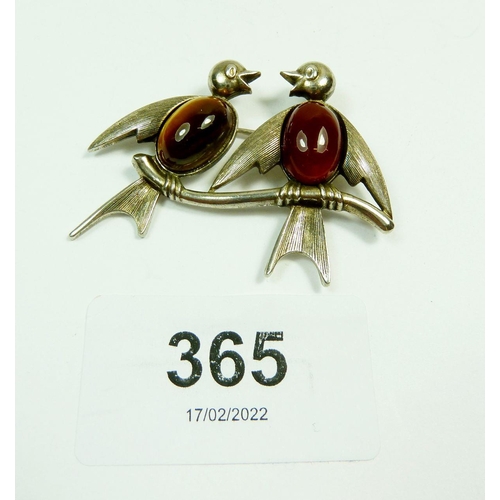 365 - A silver brooch in the form of two birds perching on a branch, their bodies set with tiger's eye and... 