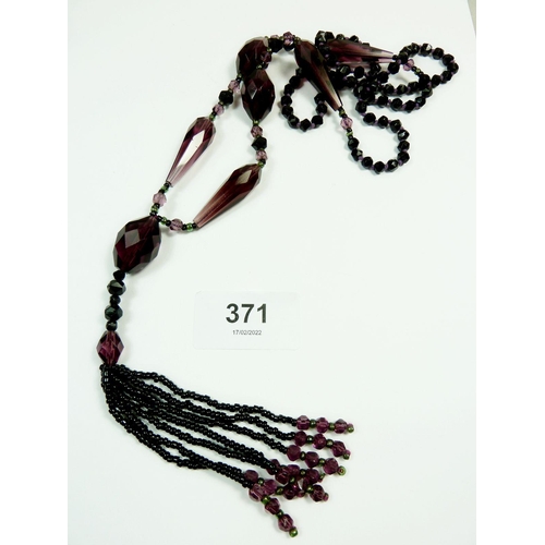 371 - An Art Deco amethyst glass tassel necklace and a stone bead necklace