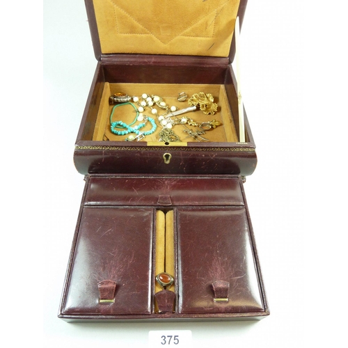 375 - An assortment of costume jewellery in a leather case to include brooches, earrings, pendants etc