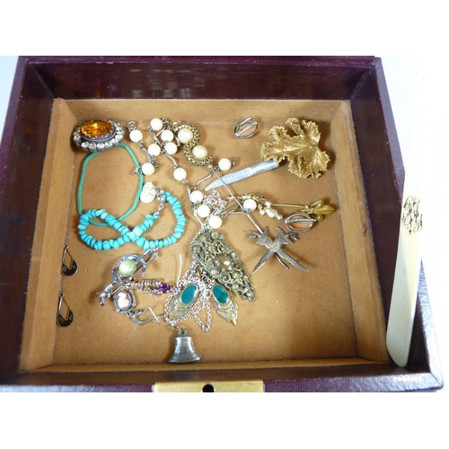 375 - An assortment of costume jewellery in a leather case to include brooches, earrings, pendants etc