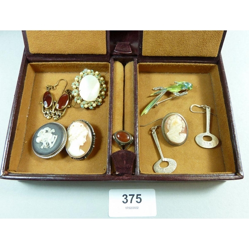 375 - An assortment of costume jewellery in a leather case to include brooches, earrings, pendants etc