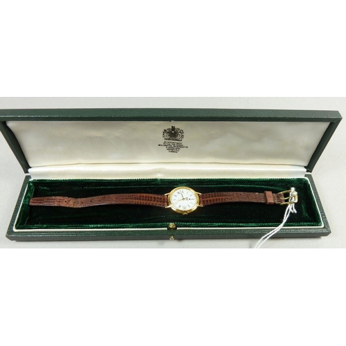 393 - An 18 carat gold Asprey wrist watch with leather strap, cased