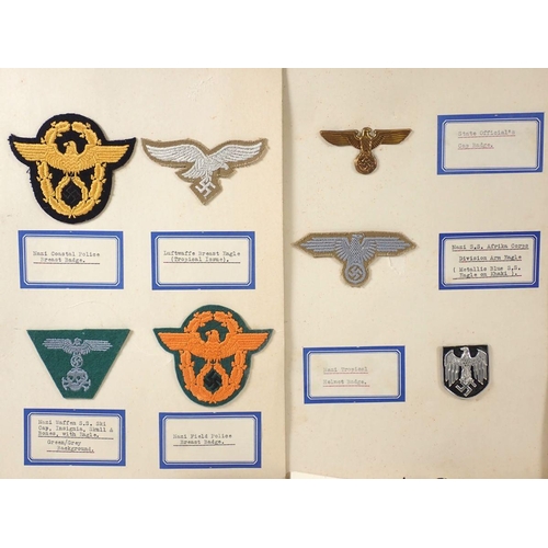 497 - A folder of German WWII Nazi cap badges and other badges, mounted on card and taped to reverse.  Inc... 