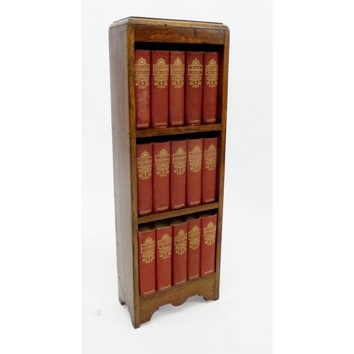 509 - An oak bookcase with a set of Charles Dickens novels published by Waverley