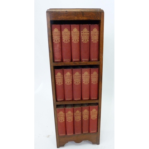 509 - An oak bookcase with a set of Charles Dickens novels published by Waverley