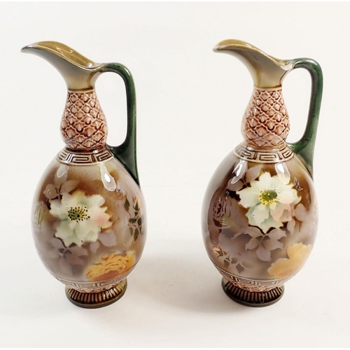 65 - A pair of continental ewers painted flowers, 17cm high