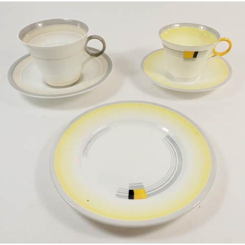 73 - A Shelley yellow tea cup trio and Shelley grey cup and saucer