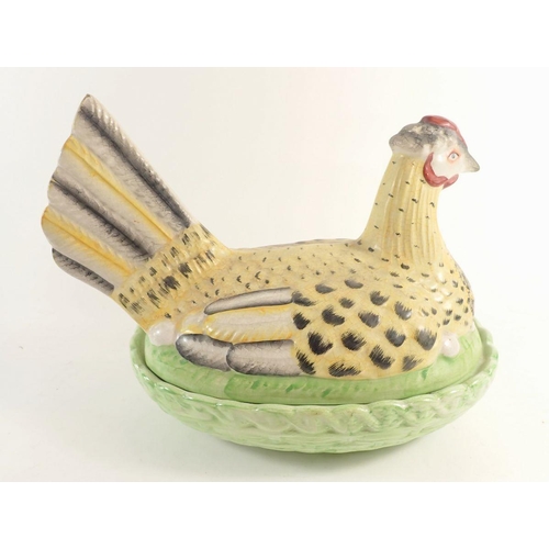 93 - A large early 20th century chicken on a basket egg holder, 31cm wide