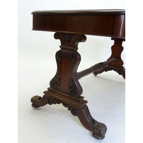 941 - A Victorian mahogany library table with carved end supports