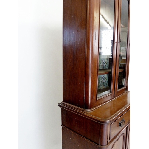 1273 - A Victorian small mahogany bookcase with two glazed doors over drawer and cupboard