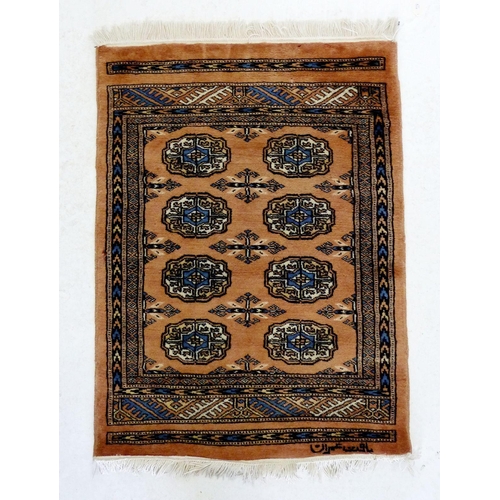 1281 - A small Turkoman silk rug with eight guls on a pale pink ground, 88 x 65cm