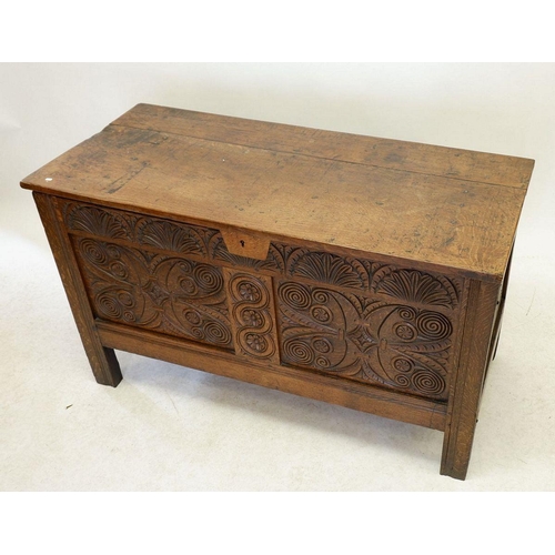 1284 - An 18th century oak coffer with incised decoration to front panels and frieze, 123cm wide