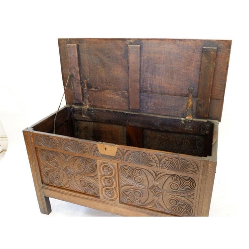 1284 - An 18th century oak coffer with incised decoration to front panels and frieze, 123cm wide