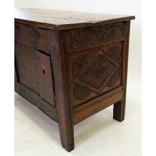 1284 - An 18th century oak coffer with incised decoration to front panels and frieze, 123cm wide