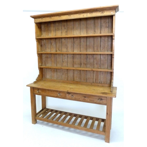 1289 - A pine dresser with heart carved frieze over display shelves with two drawers and pot board below, 1... 