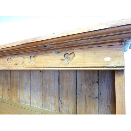 1289 - A pine dresser with heart carved frieze over display shelves with two drawers and pot board below, 1... 