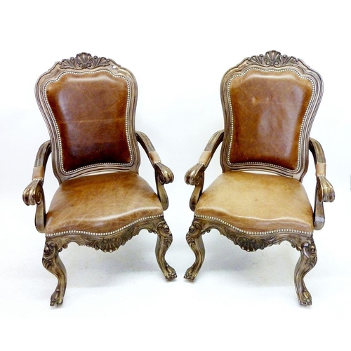 1295 - A pair of French style large leather upholstered armchairs with carved shell backs and scroll over a... 