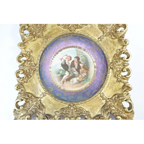 444 - A pair of gilt framed prints after Murillo on porcelain, 24cm diameter